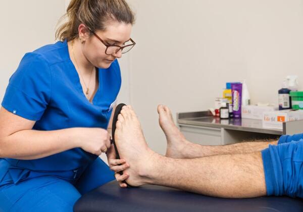 Prosper Health Group podiatrist fitting orthotics to patient in Highton