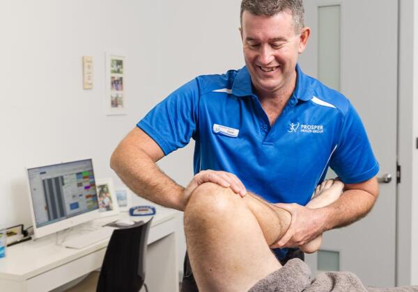 Physiotherapist at Prosper Health Group treating a patient's leg in Colac